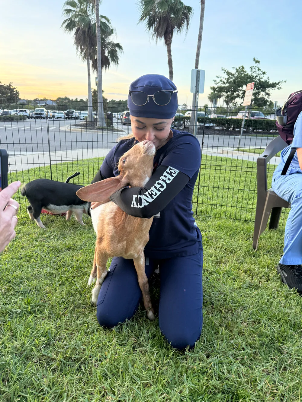 An AdventHealth Team member hugging a goat