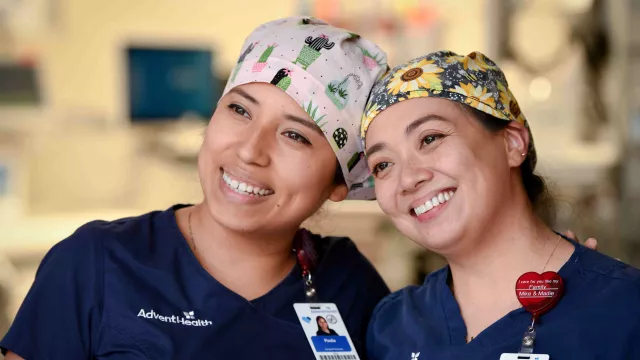 Two smiling nurses standing next to each other