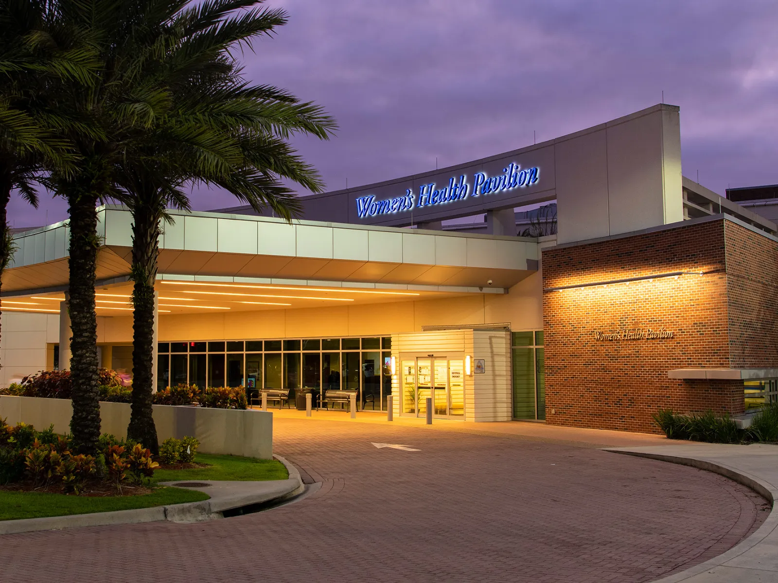 AdventHealth Tampa's Women's Health Pavilion entrance at night