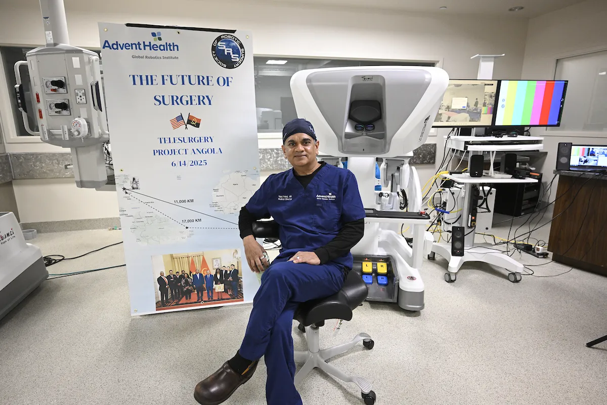 Dr. Vip Patel with Angola surgery banner