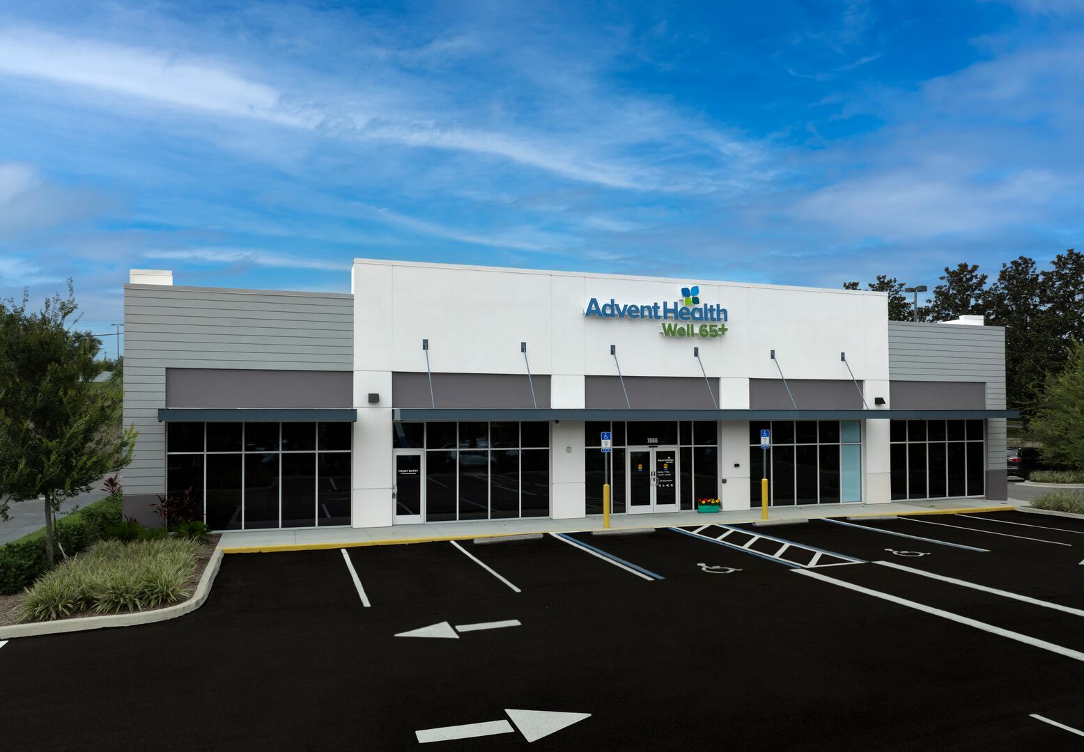 Exterior of the AdventHealth Well 65+ Zephyrhills clinic with parking spaces in front.