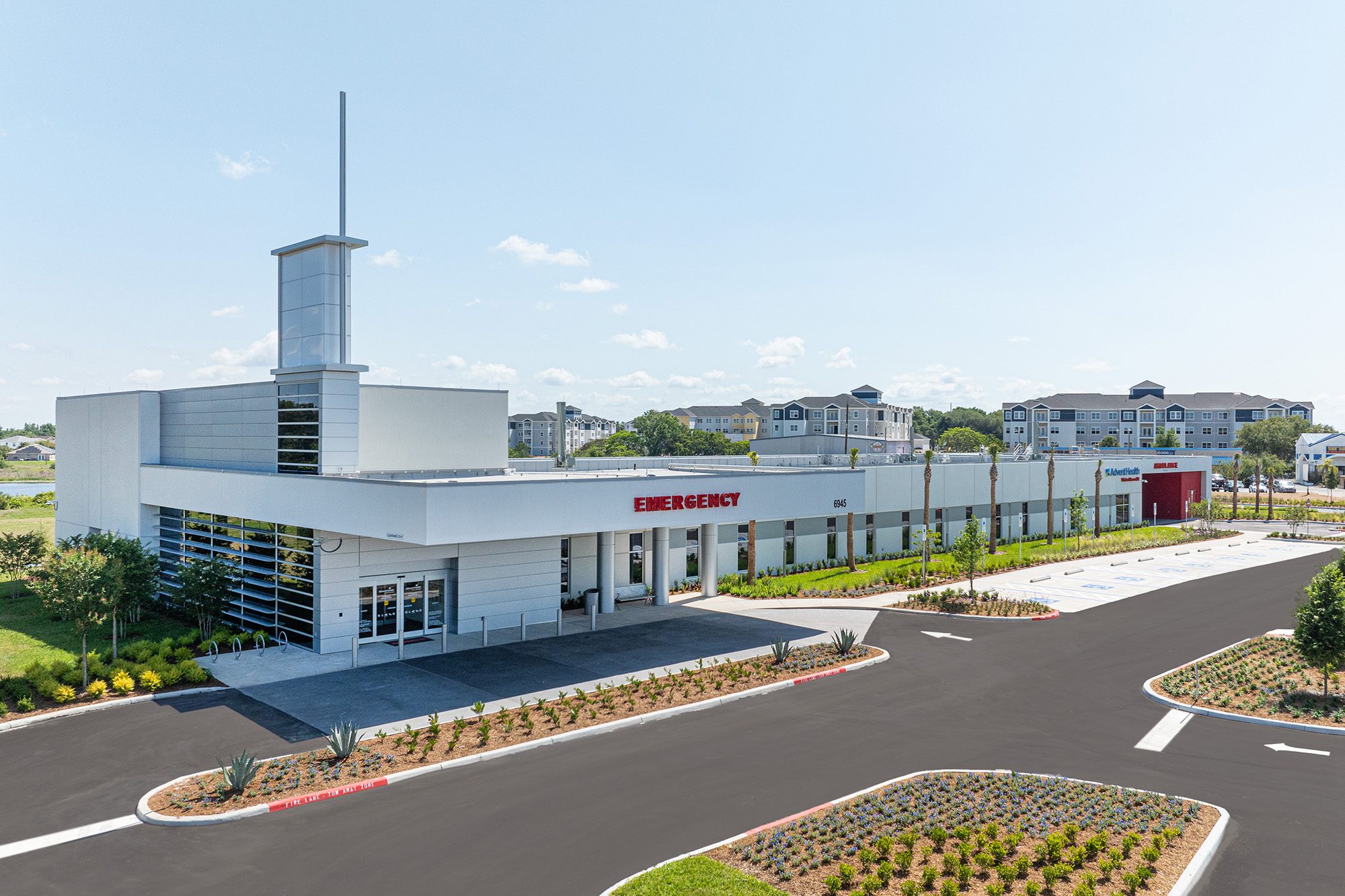 Exterior of AdventHealth Winter Haven ER with emergency entrance and tower.