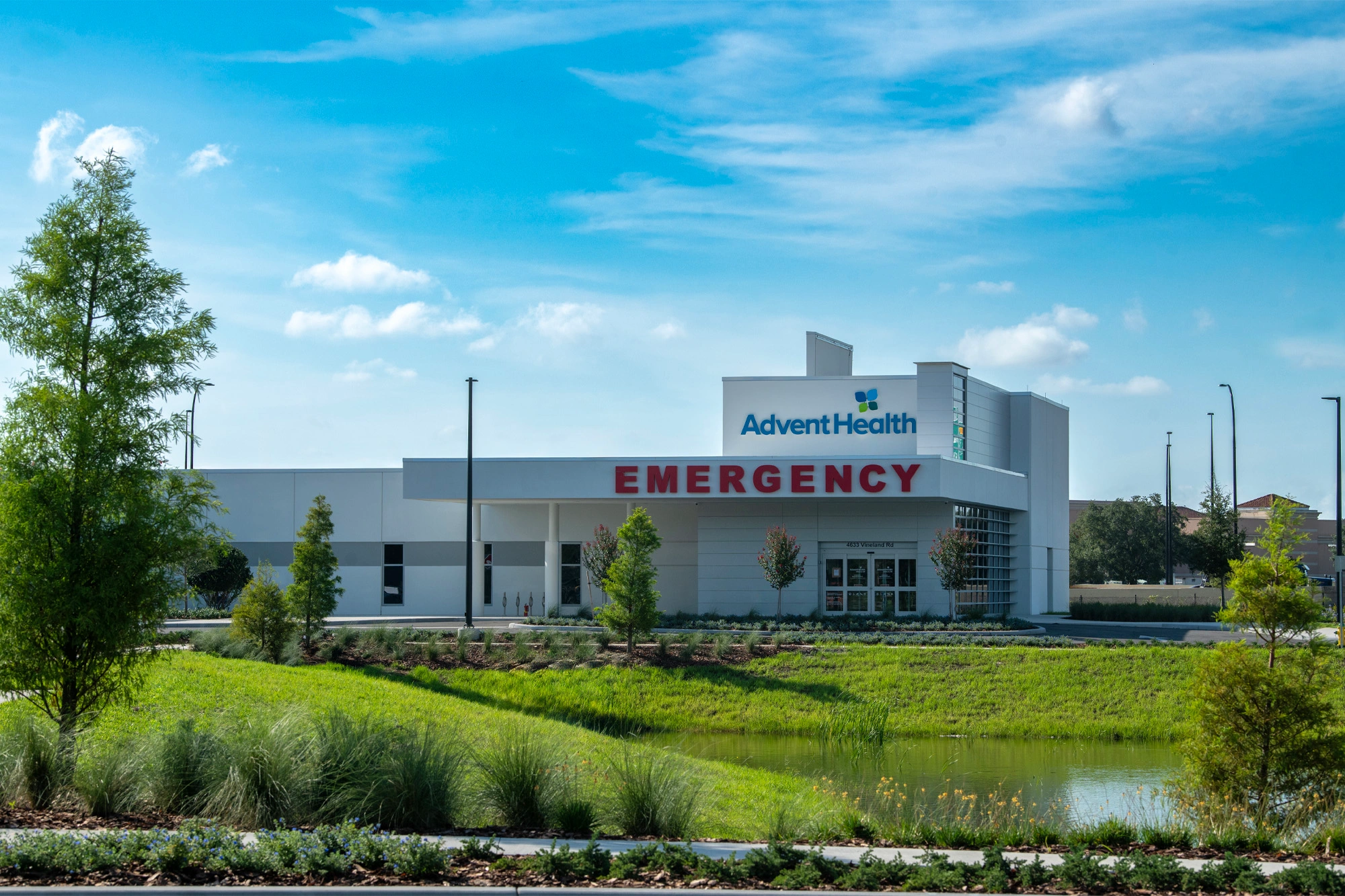 Exterior of AdventHealth Millenia ER with emergency entrance and signage.
