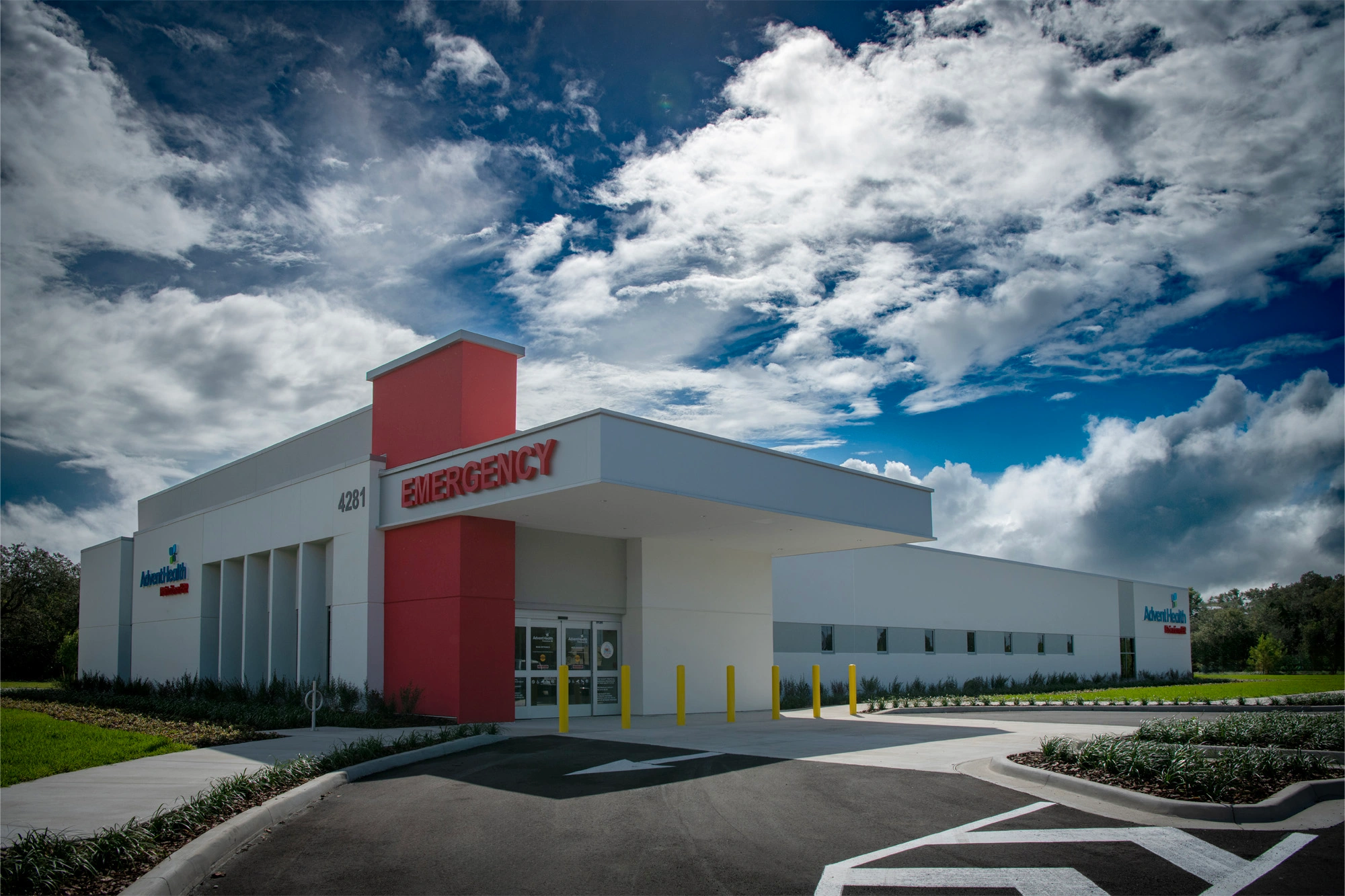 Exterior of AdventHealth Poinciana ER with emergency entrance and signage.