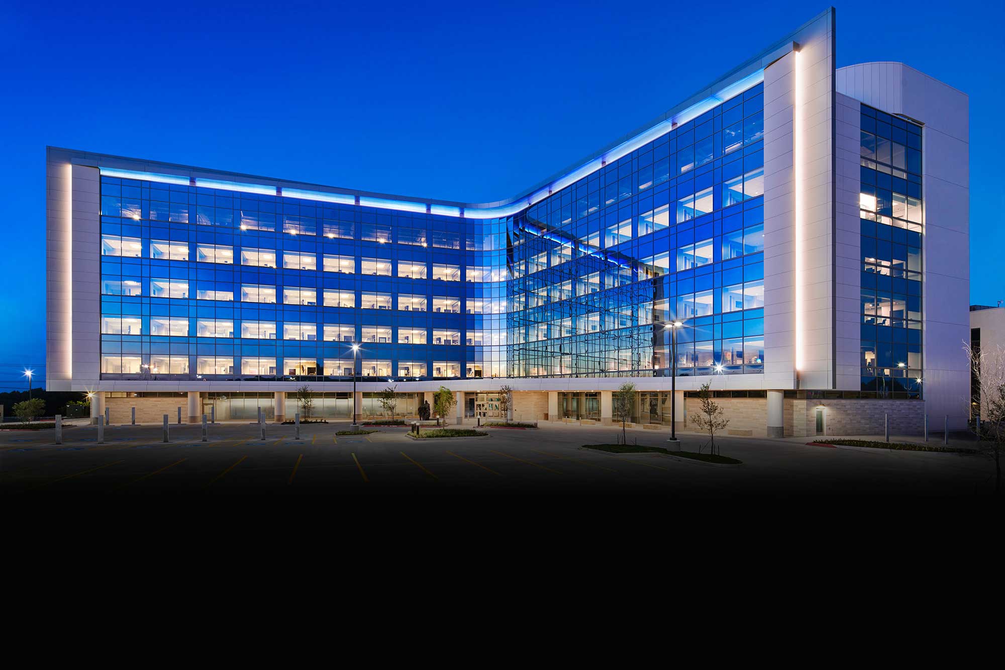 Texas Health Huguley hospital building — nighttime exterior view.